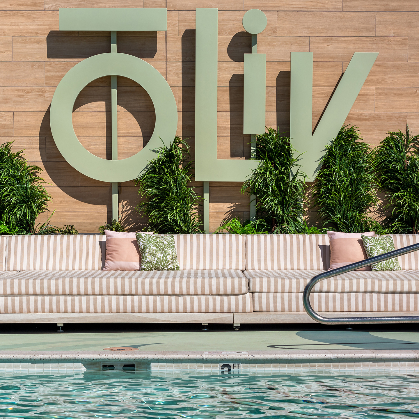 oLiv logo next to a swimming pool