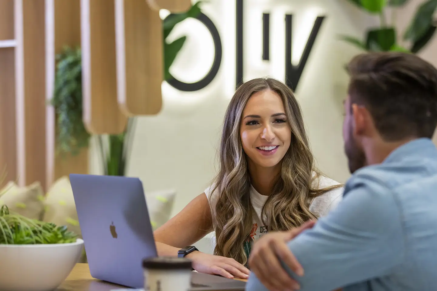 two students have a conversation in the ōLiv Tempe lobby