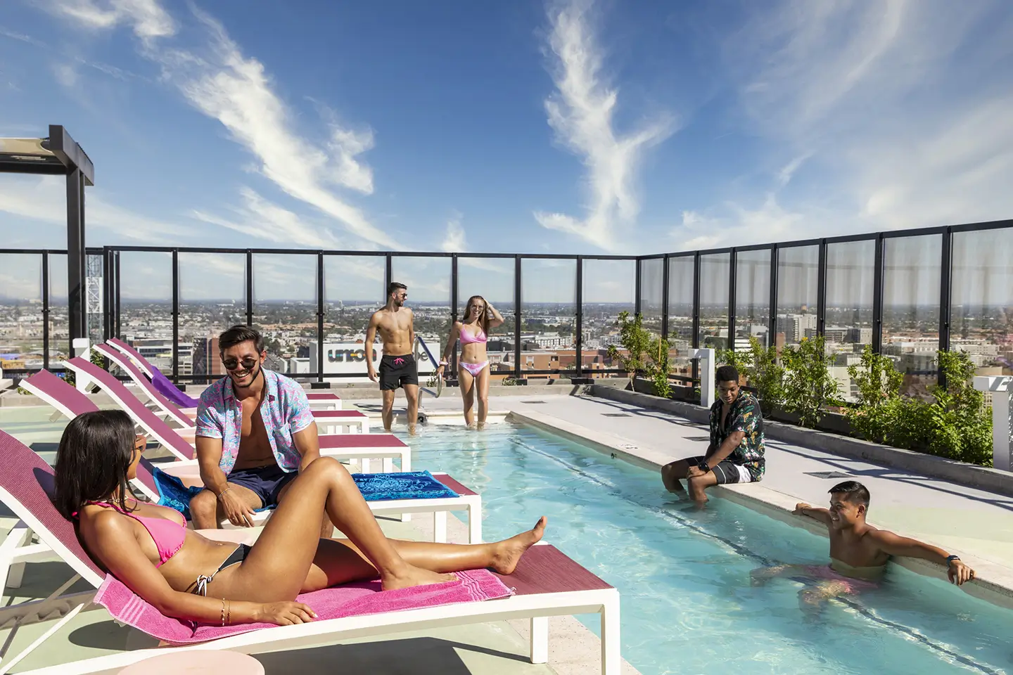 students gathering at the pool at ōLiv Tempe